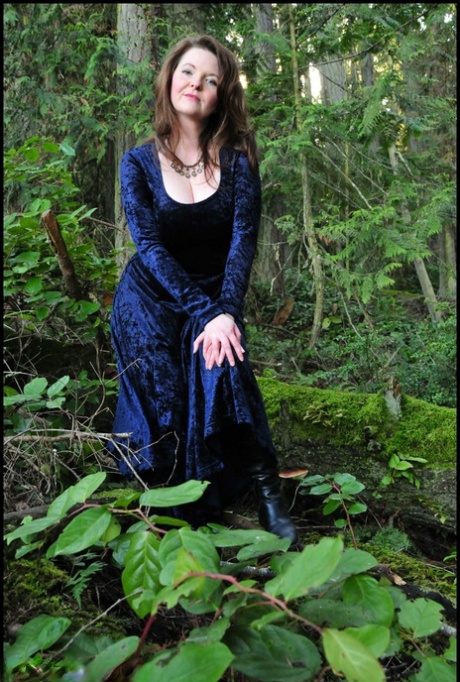 Mature woman Tasty Trixie heads into the woods to flash in a long velvet dress 63332146