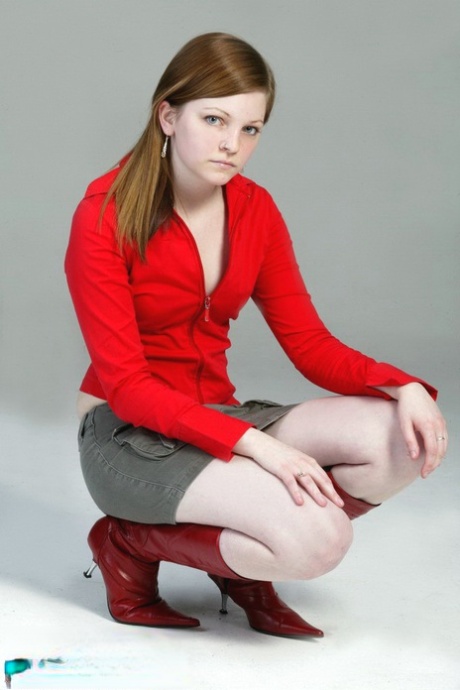 Pale redhead Lilly slowly strips to a black G-string and red leather boots 49586711