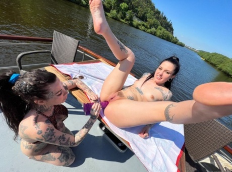Tattooed girls flash their breasts before having sex on a boat 24212900